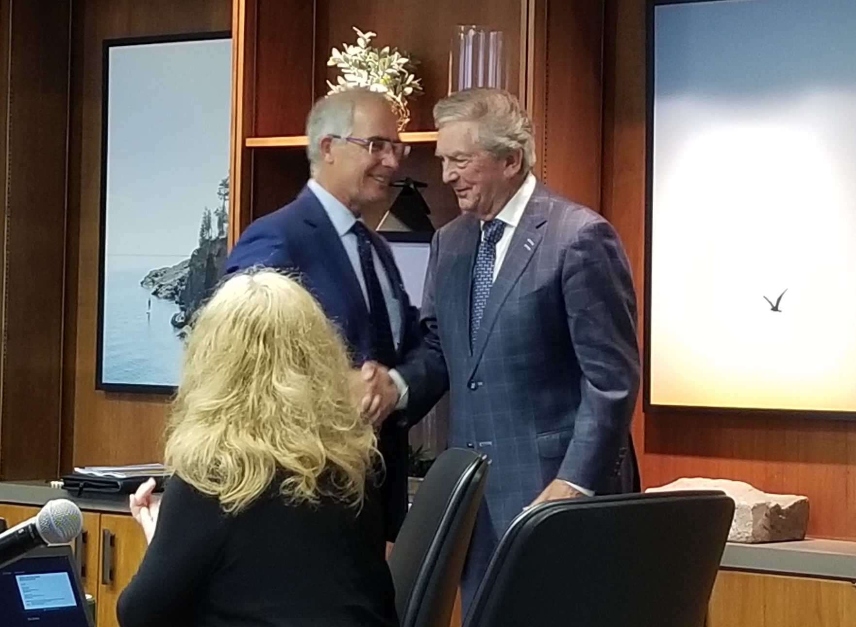 Former trustee and NMU alumnus Scott Holman (right) congratulated by Board Chair Robert Mahaney.