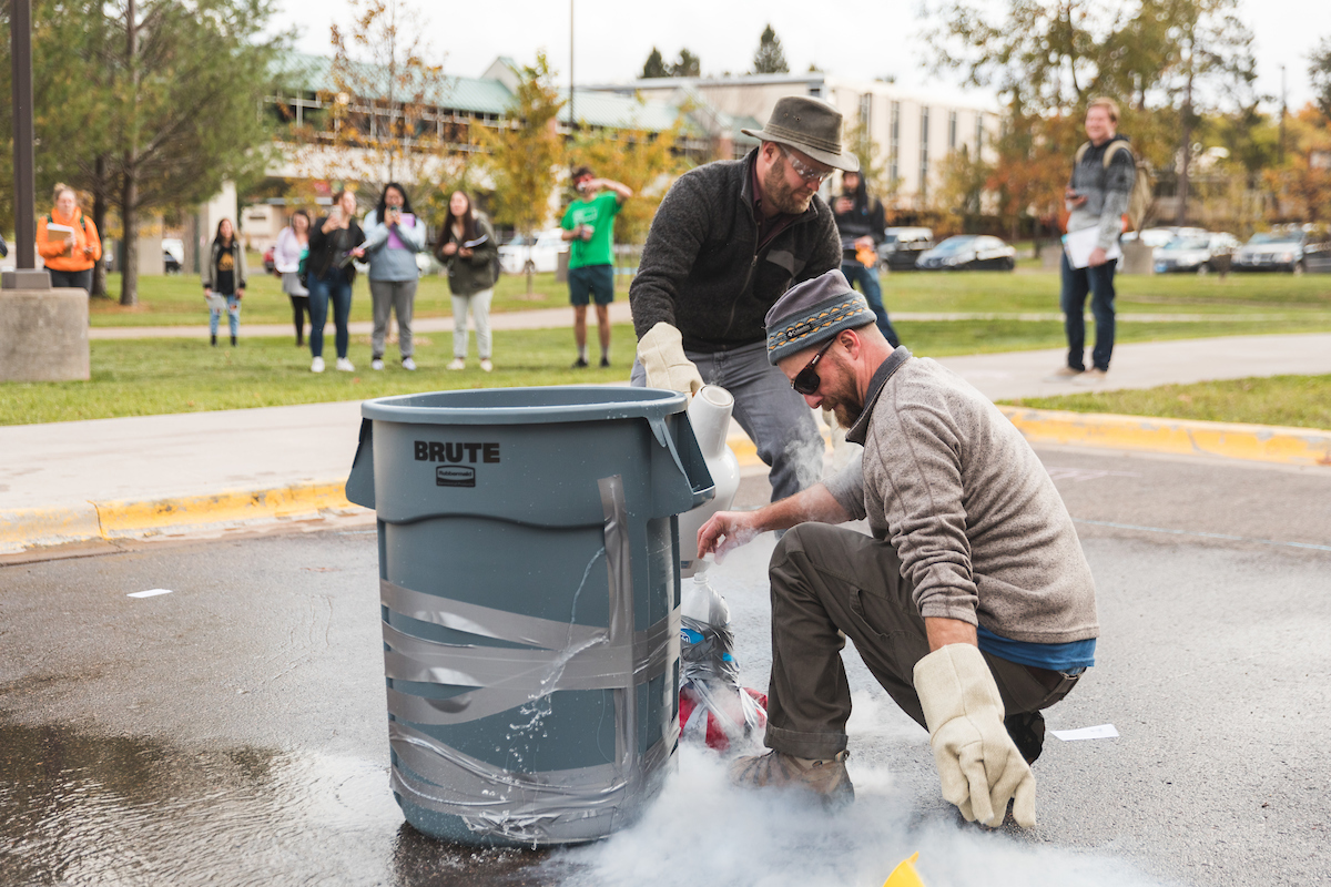 Lechner (kneeling) and colleague Matthew Van Grinsven prepare the liquid nitrogen.