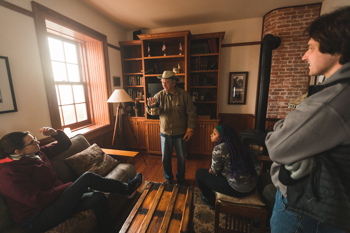 Owner Scott Holman shows an object to the group