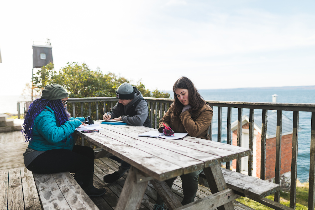 The three students with their journals