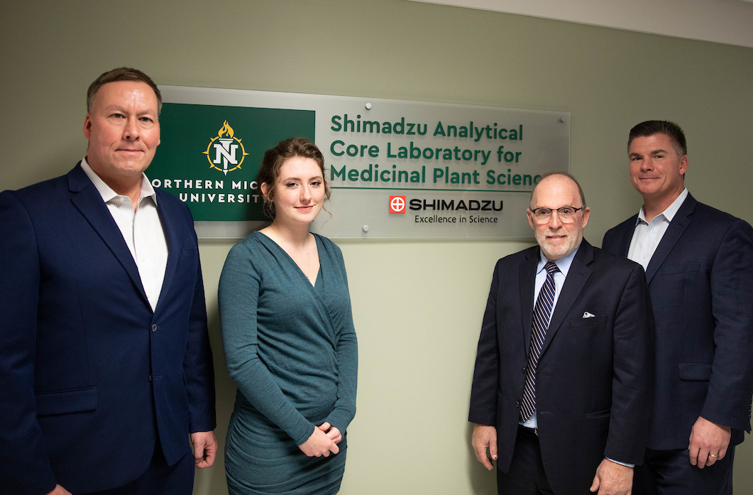 From left: Scott Kuzdzal of Shimadzu, NMU student Josie Mollohan, NMU President Fritz Erickson and Phil Martin of Shimadzu