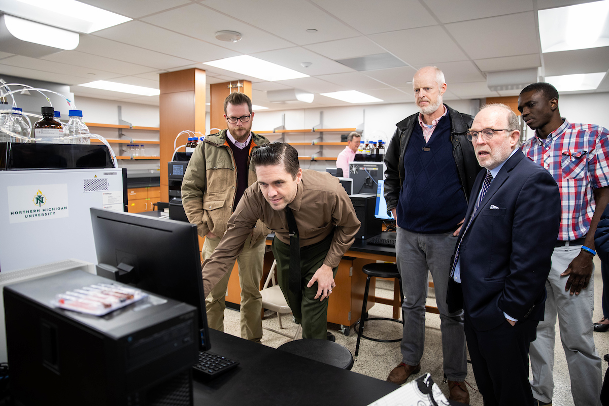 NMU faculty, staff and administrators tour the lab.