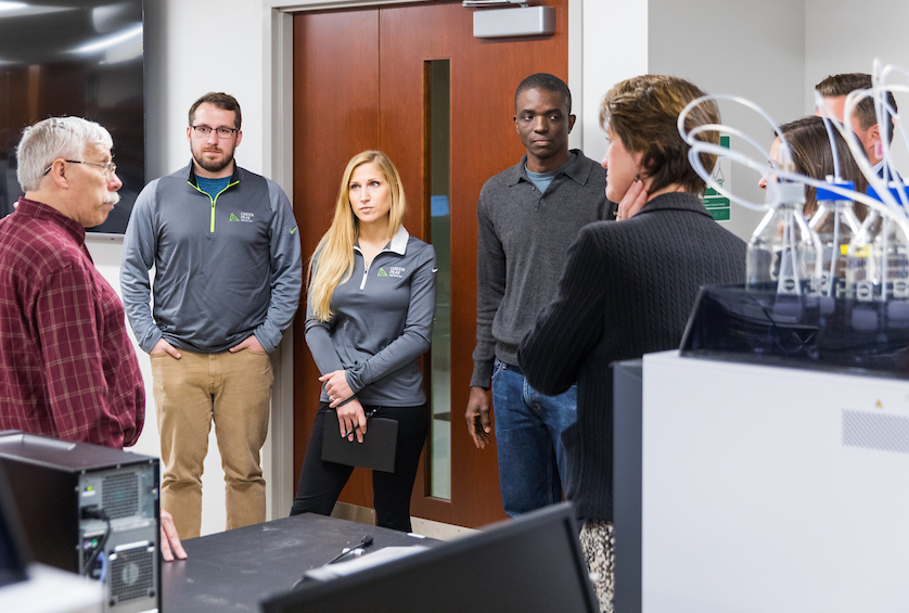 Frisk and his Green Peak Innovations colleagues join NMU faculty for a tour of the new Shimadzu laboratory.