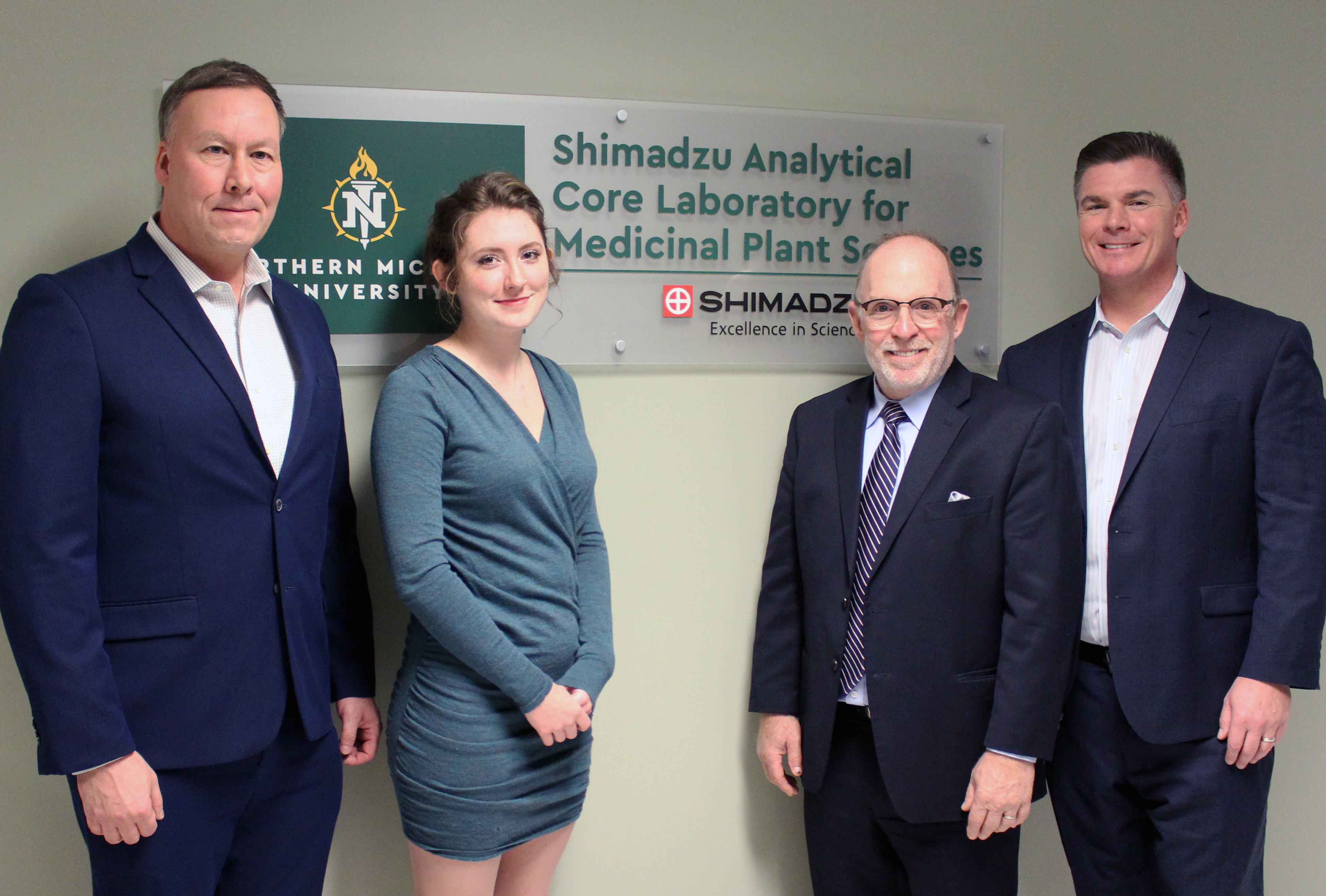 At the dedication (from left): Scott Kuzdzal of Shimadzu, NMU student Josie Mollohan, NMU President Fritz Erickson and Phil Martin of Shimadzu