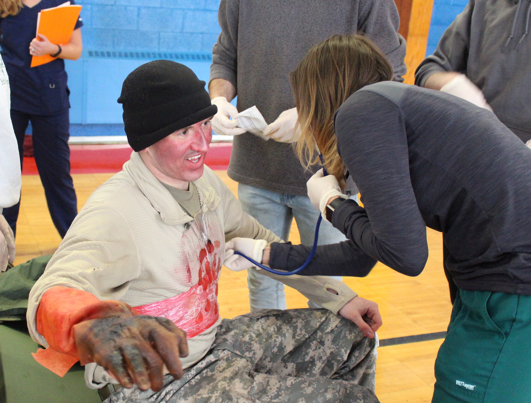 A patient with torso and other injuries receives treatment.