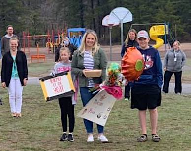 Sheltrow with her children and others during a "drive-by" congratulatory event at the school.