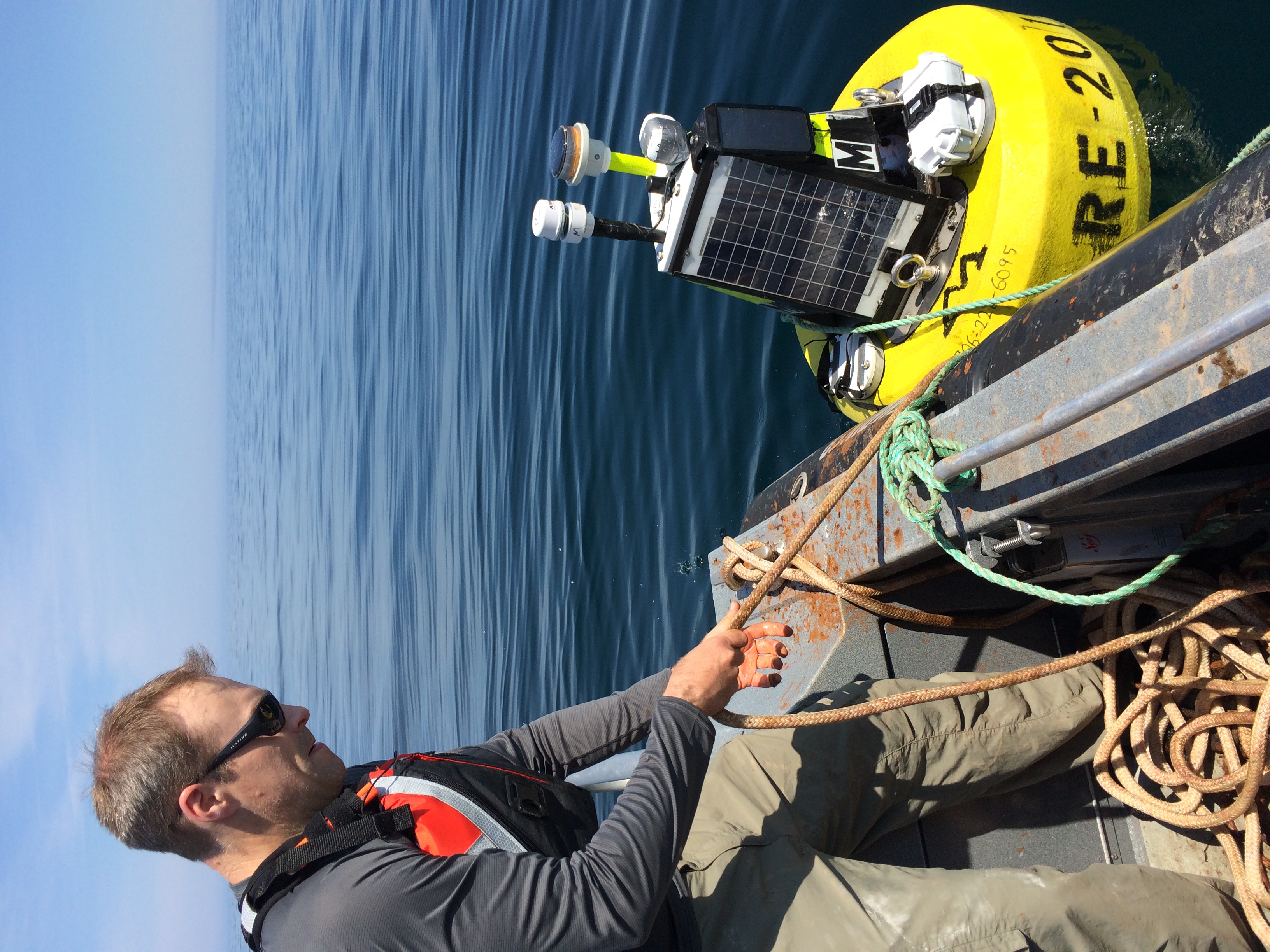 Jeff Koch of the Superior Watershed Partnership prepares to launch the buoy.