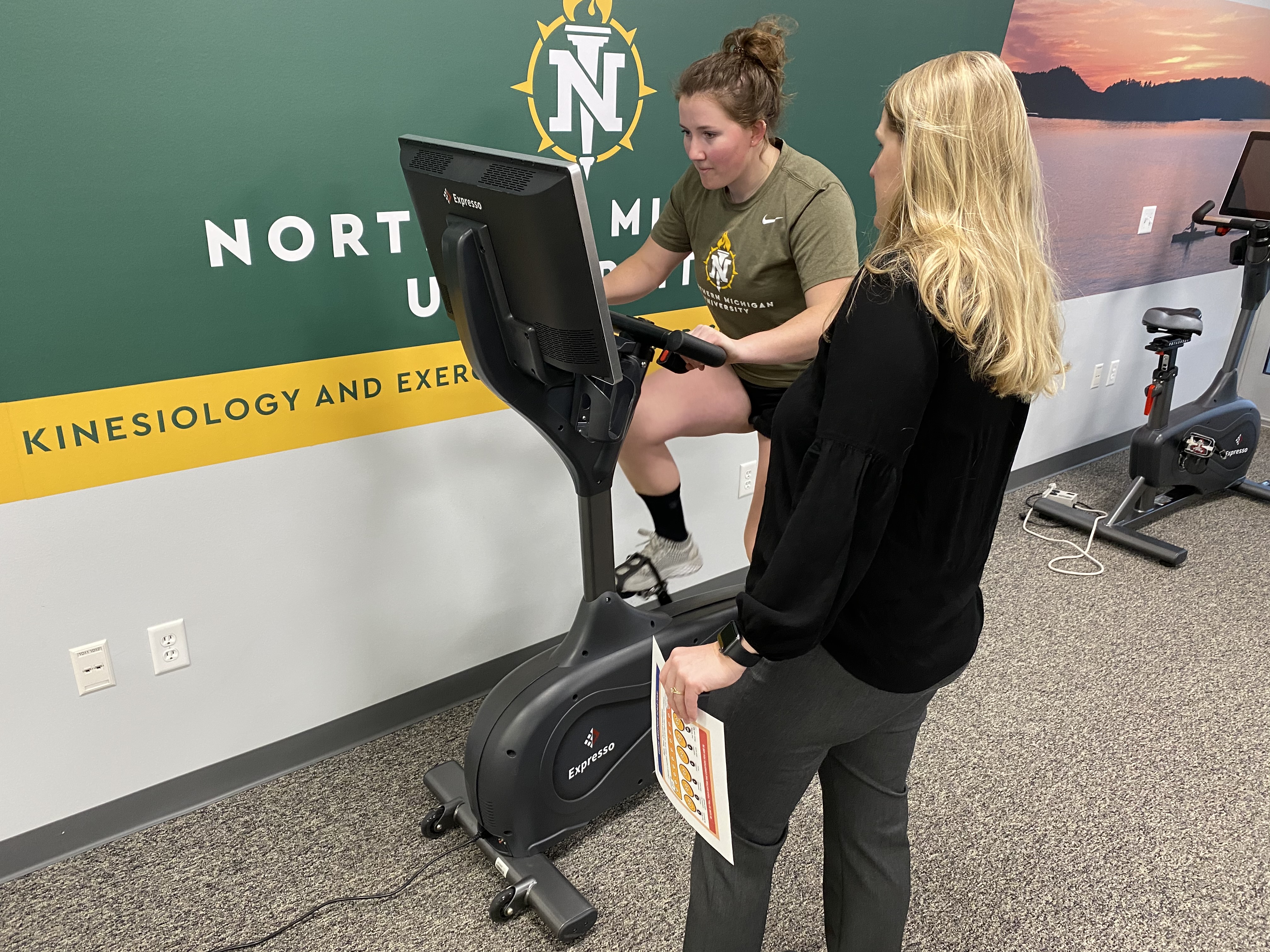 Moore with Brett Fox on a bike tasking the cardiovascular system and vision system with a bit of balance.