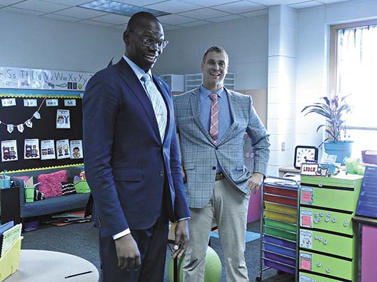 Hill (right) with Lt. Gov. Garlin Gilchrist during a 2019 elementary school visit (Garrett Neese/Daily Mining Gazette)