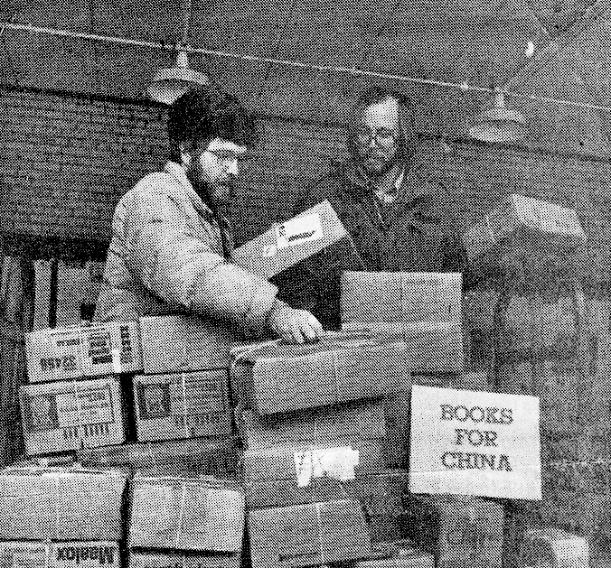 As a student, Seppanen (right) and his NMU adviser, Jon Saari, prepared a collection of books to ship to an English-language program in China.