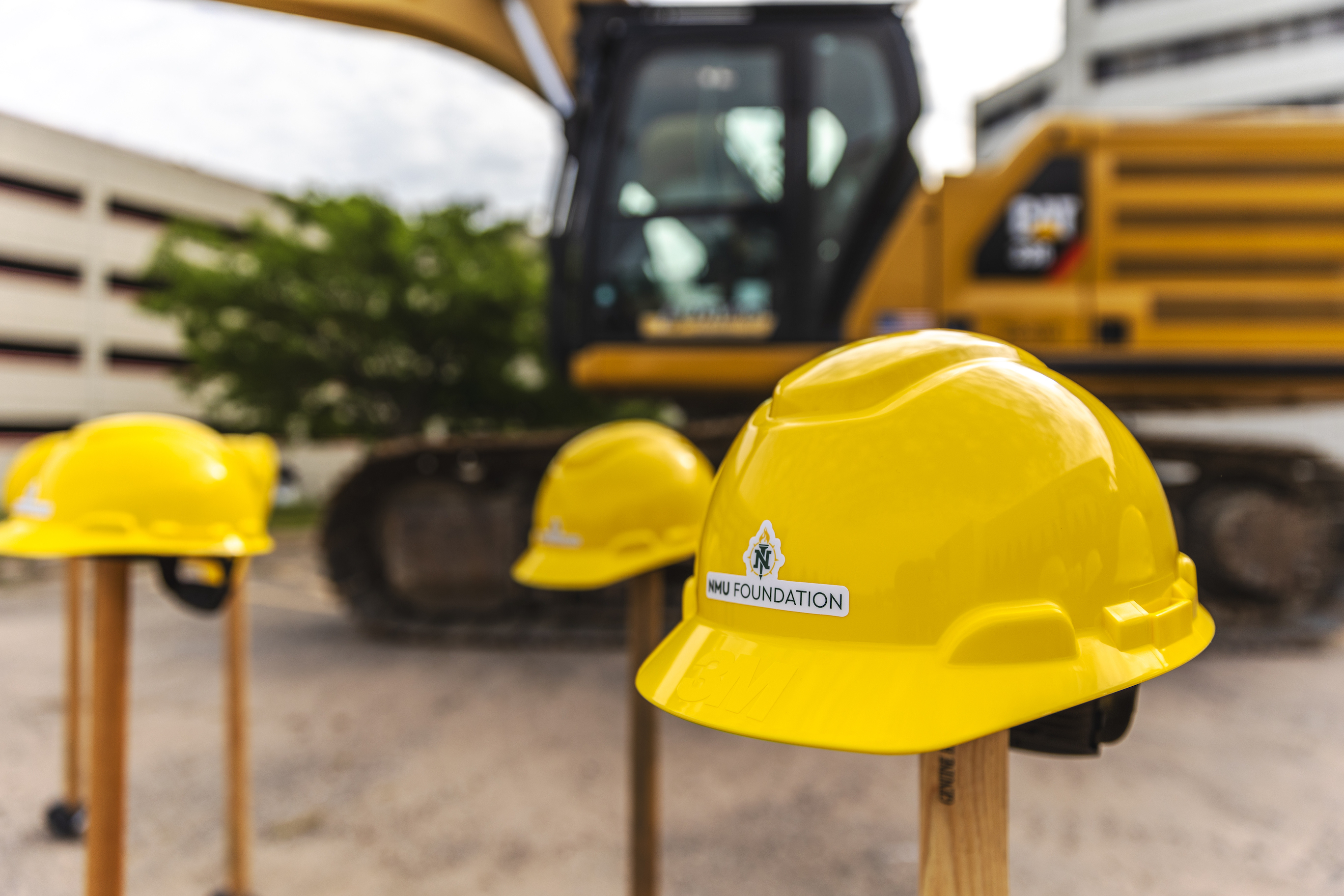 NMU Foundation-branded hard hats at the demolition site