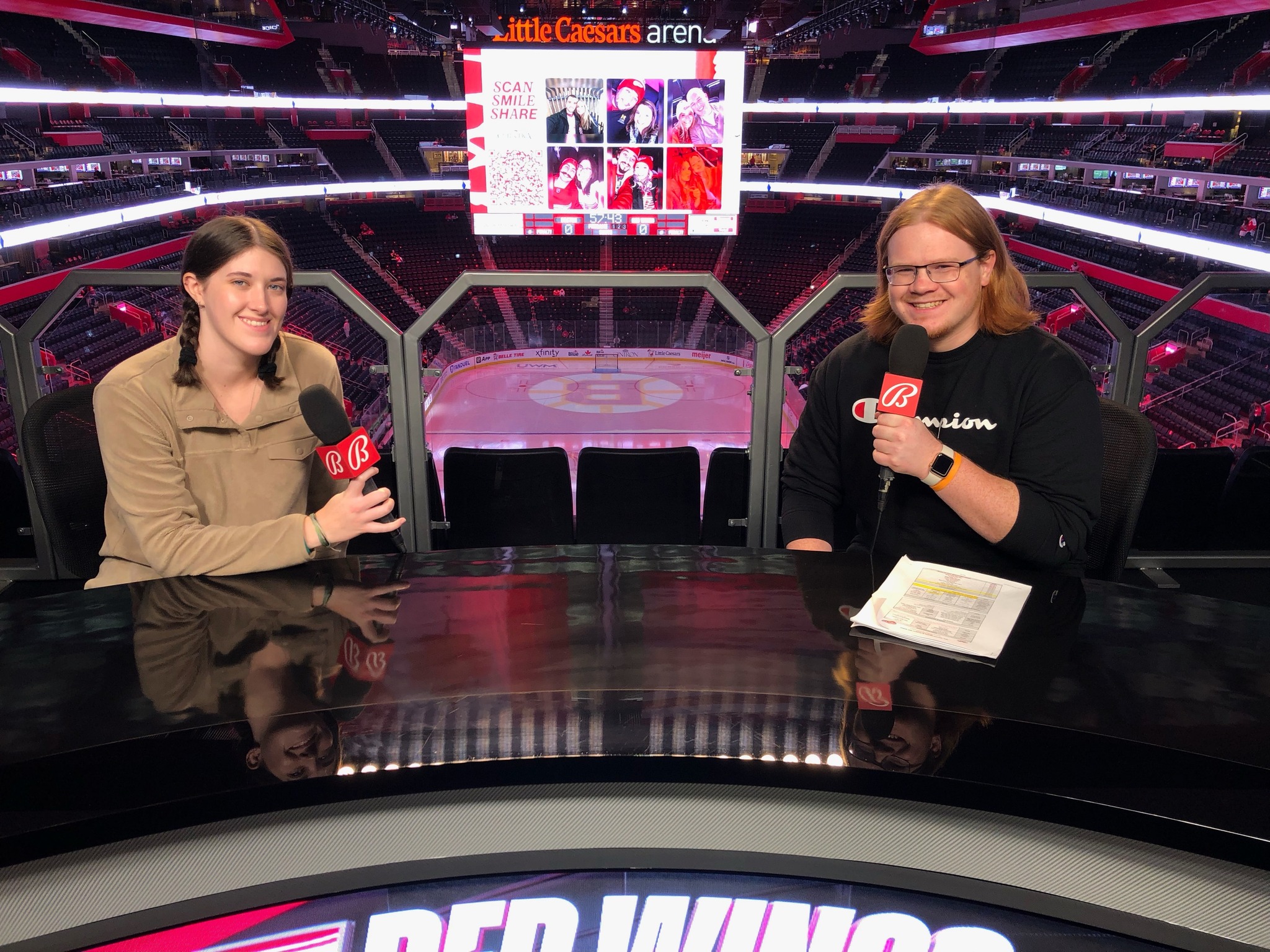 Two NMU students at the Bally Sports Detroit desk