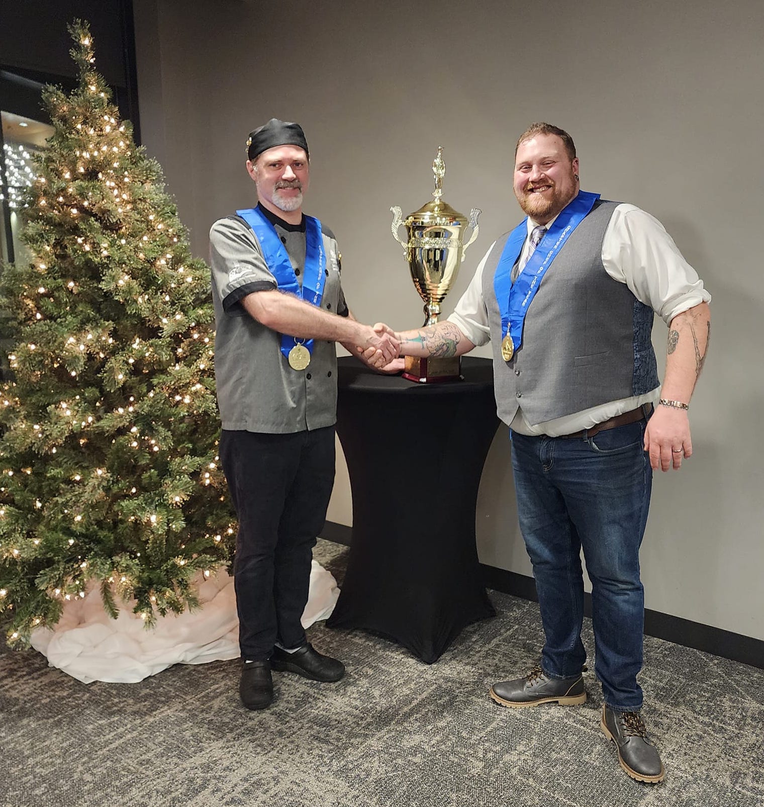 Estes (left) receiving the award from the previous U.P. Culinarian of the Year recipient Christopher Durley.