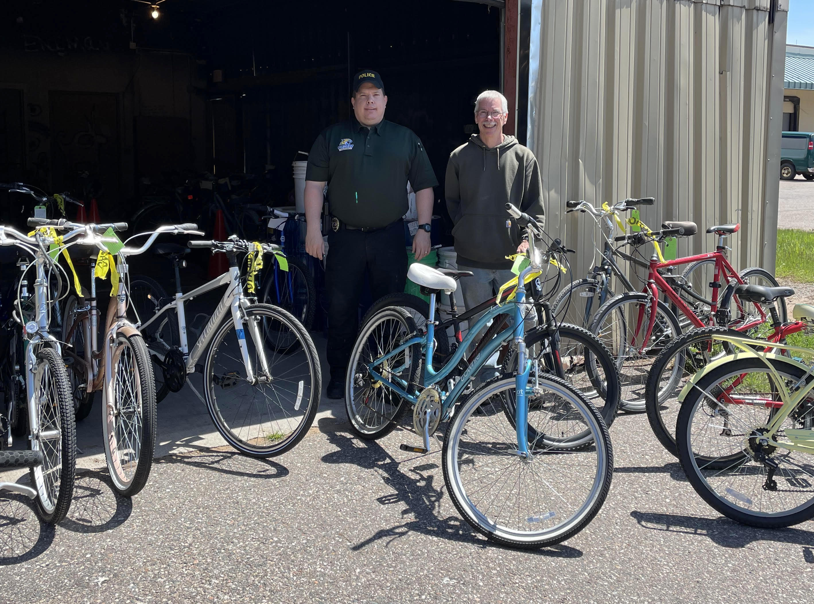 From left: NMU PD Sgt. Tom Parks and Ripple Effect adviser Peter Holliday with abandoned bikes.