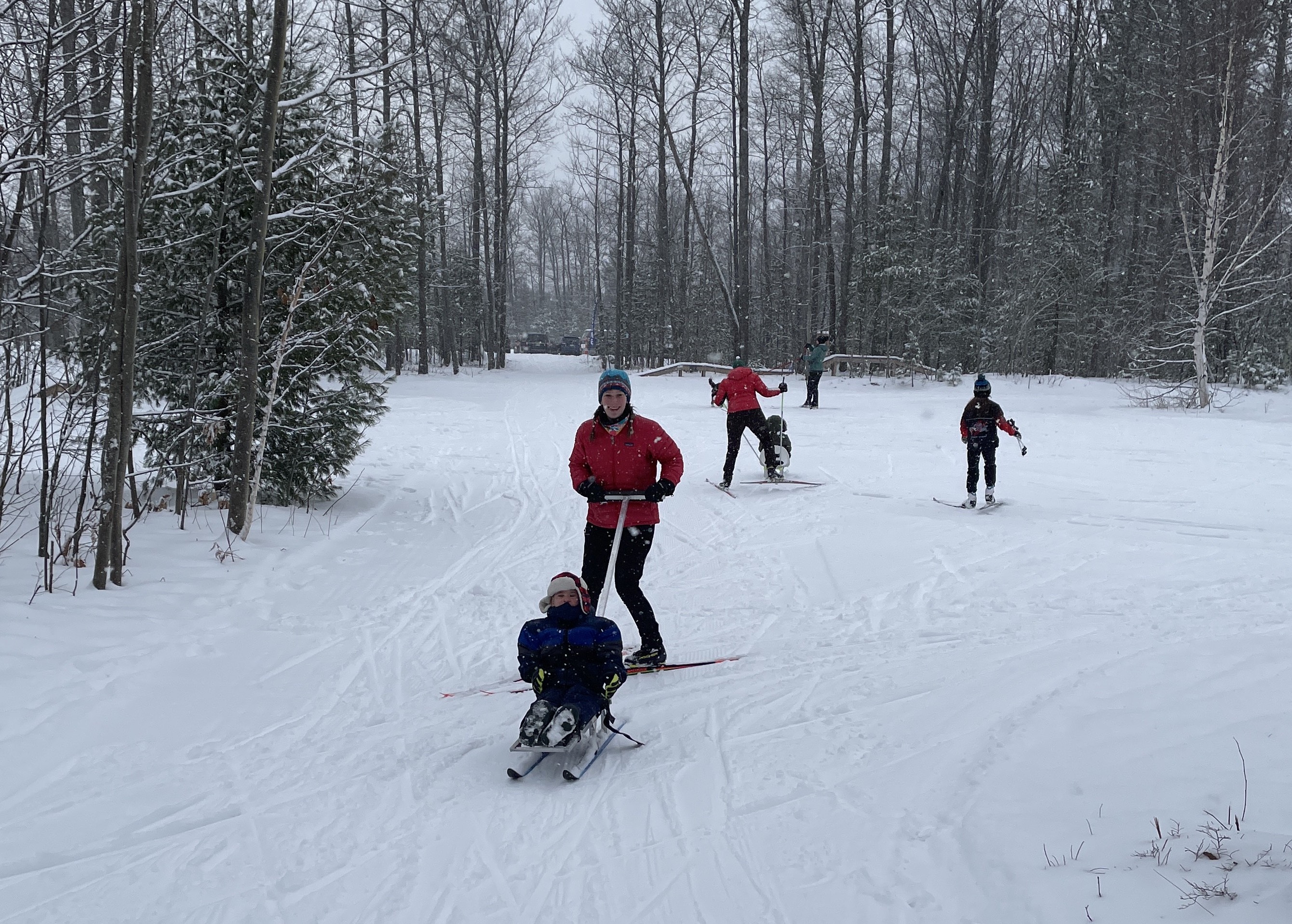 Kids test out sit-skis. The SSC has six total: two previously purchased and the four contributed by NMU.