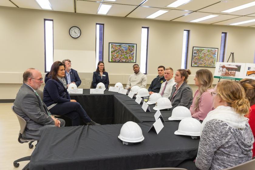 Governor with students and administrators