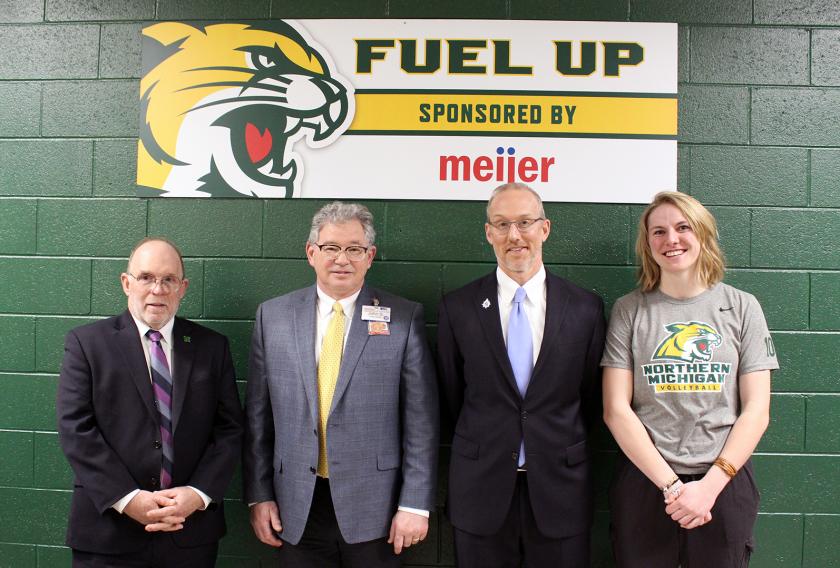 NMU President Fritz Erickson, Marquette Meijer Director John Spaulding, NMU Athletics Director Forrest Karr and Wildcat volleyball player Sarah Kuehn