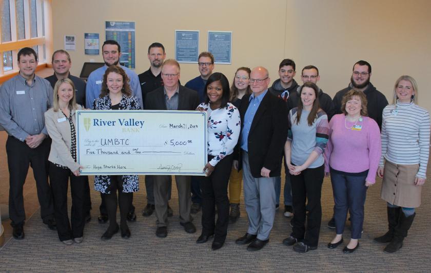 Pictured (from left) are: River Valley Bank representatives Jeff Prophet, Mike Mattila, Ashley Cody, Jake Trucco and Lea Dziesinski; Shane Kentala of UPHS; Paul Mann of NMU; Greg Lahti and Dr. Sonia Geschwindt of UPHS Neurosurgery; NMU reps Megan Altekruse, Rob Winn, Joe Duffy, Amber LaCrosse, and Dan Raymond; Joy Osti of UPHS; Nick Shortreed of NMU; and Emily Wright of UPHS.