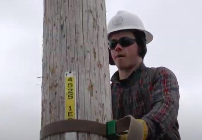 Carr climbing an electrical pole