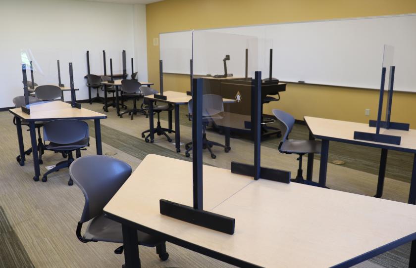 Classroom with plexiglas barriers on tables