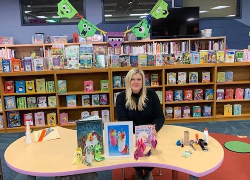 Schroeder helped students make unicorn finger puppets from toilet paper tubes, inspired by "Uni the Unicorn." The Creepy Underwear above her head were inspired by "Creepy Pair of Underwear"