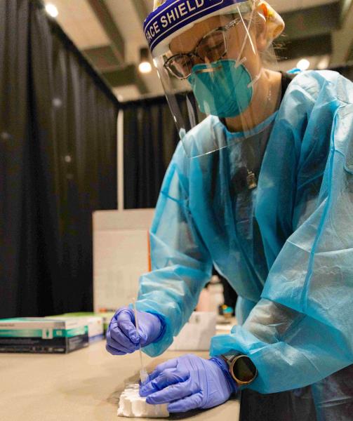 NMU stock photo of campus mass testing event and the PPE nursing students wear regularly.