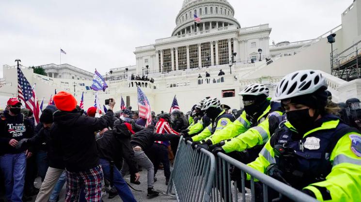 Protesters try to break through a police barrier