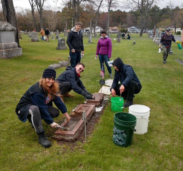 Volunteers cleaning tombstones