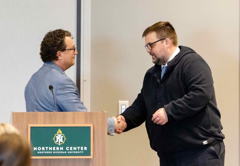 Doney (right) receiving the award from Joe Lubig, associate dean and director of Education, Leadership and Public Service