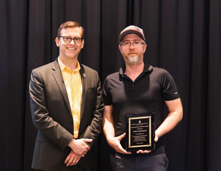 Buckmaster (right) with President Brock Tessman