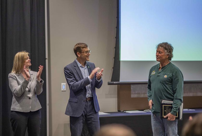 Don Wernholm (right), receives one of the Excellence in Service Awards from Rhea Dever and President Brock Tessman