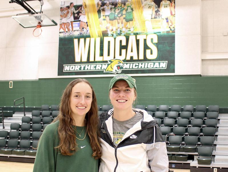 Makaylee Kuhn and Sarah Kuehn in Vandament Arena, home court for NMU volleyball and basketball.