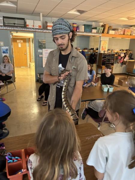 Zivnoska with a snake during a presentation