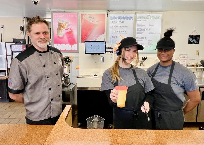 From left: Executive Chef Derek Estes and student employees Evie McCully and Teiolla Harvey present a mango Noba freeze with boba.