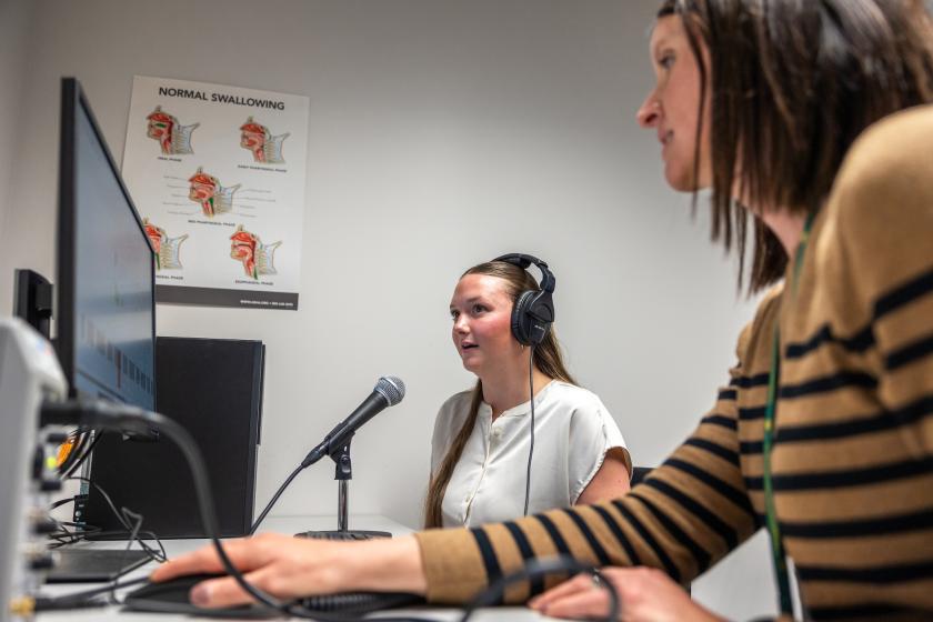 Isaacson (right) and a student in NMU's Speech-Language-Hearing Clinic