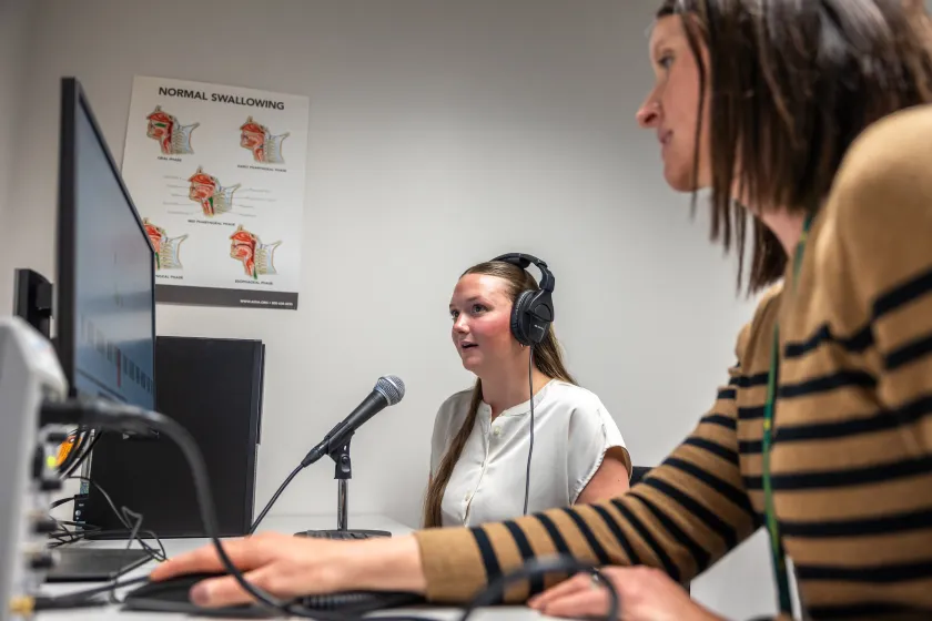 Isaacson (right) and a student in NMU's Speech-Language-Hearing Clinic