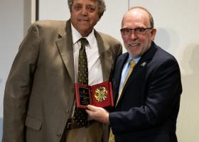 Tom Fish (left) accepting his award from NMU President Fritz Erickson