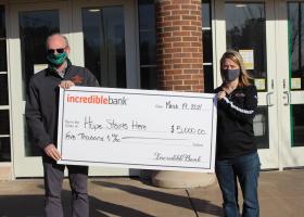 Robb Winn of NMU and the UMBTC receives a title sponsorship check from Ashley Cody of IncredibleBank.