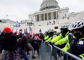 Protesters try to break through a police barrier