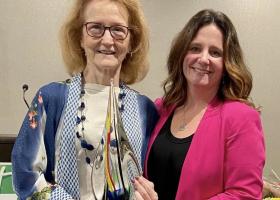 Contois (left) receiving her Evergreen Award