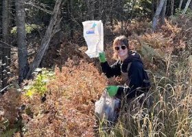 Rosie Mousseau picking up trash along County Road 550