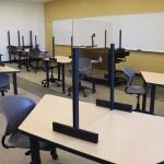 Classroom with plexiglas barriers on tables