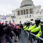 Protesters try to break through a police barrier