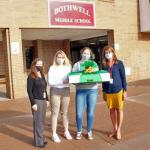 NMU students Sydney Wickstrom and Mackenzie Meyer (second and third from left) make a delivery to Bothwell personnel.