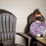 NMU student employee Raija Stille tries out one of the chairs near the sun lamp.