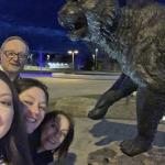 A selfie of the Young family by the wildcat statue on campus