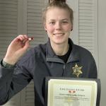 Esther Byington with her lifesaving certificate and pin (later replaced with a medal)