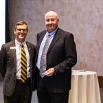 Charles Hawes accepts the Alumni Service Award from NMU President Brock Tessman