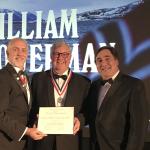 Bowerman (center) being presented with the medal and certificate for the Lowell Thomas Award by The Explorers Club President Richard Garriott (left) and Vice President for Flags and Honors Martin Nweeia (right).