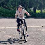 Happy student Trinity Valentin tests out her new bike.